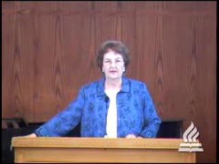 woman standing at podium speaking at DTS Chapel