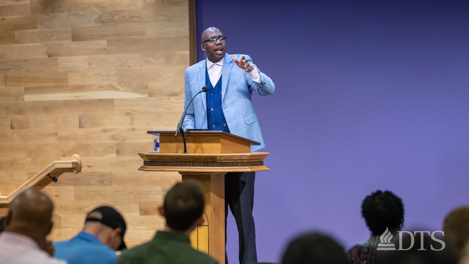 man standing at podium speaking at DTS Chapel