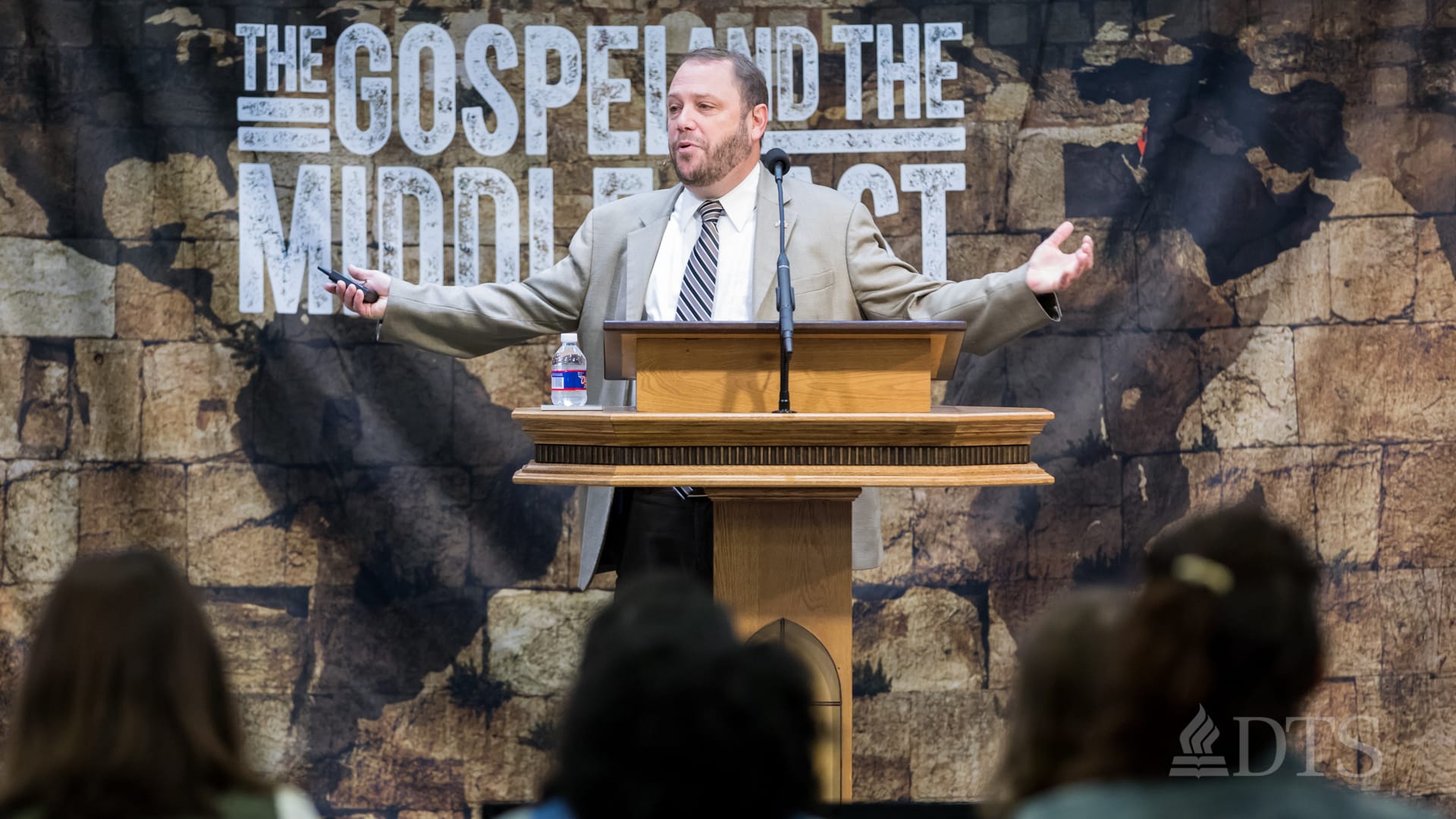 man standing at podium speaking at DTS Chapel
