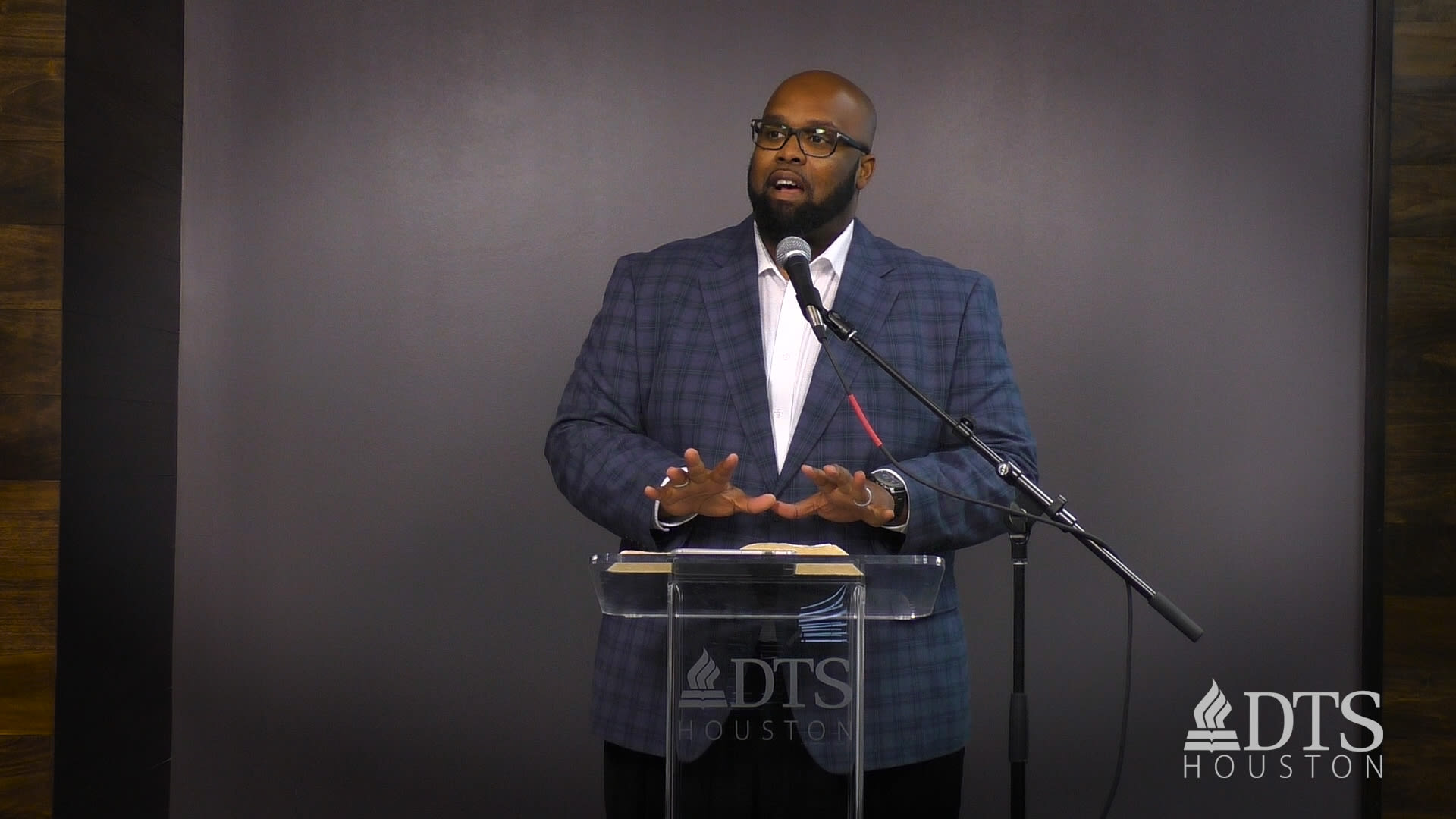 man standing at podium speaking at DTS Chapel