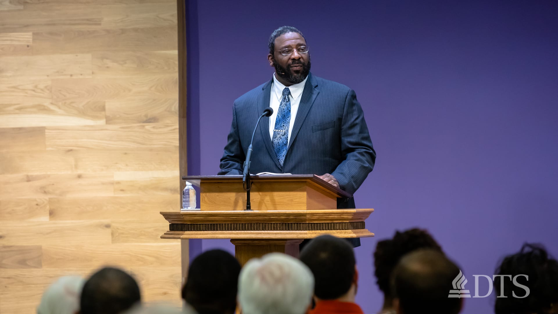 man standing at podium speaking at DTS Chapel