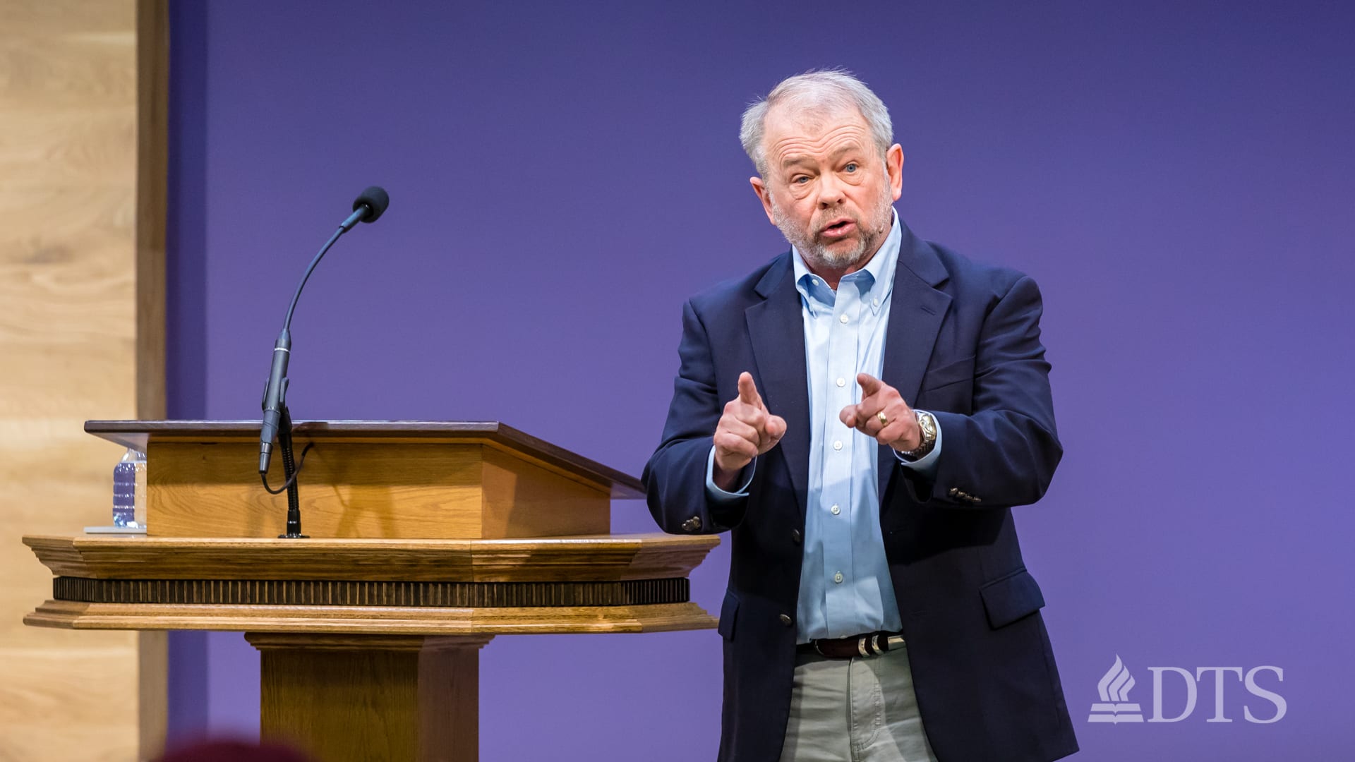 man standing near podium speaking at DTS Chapel