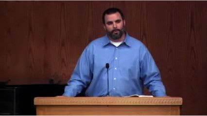 man standing at podium speaking at DTS Chapel