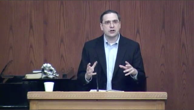 man standing at podium speaking at DTS Chapel