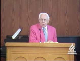 man standing at podium speaking at DTS Chapel