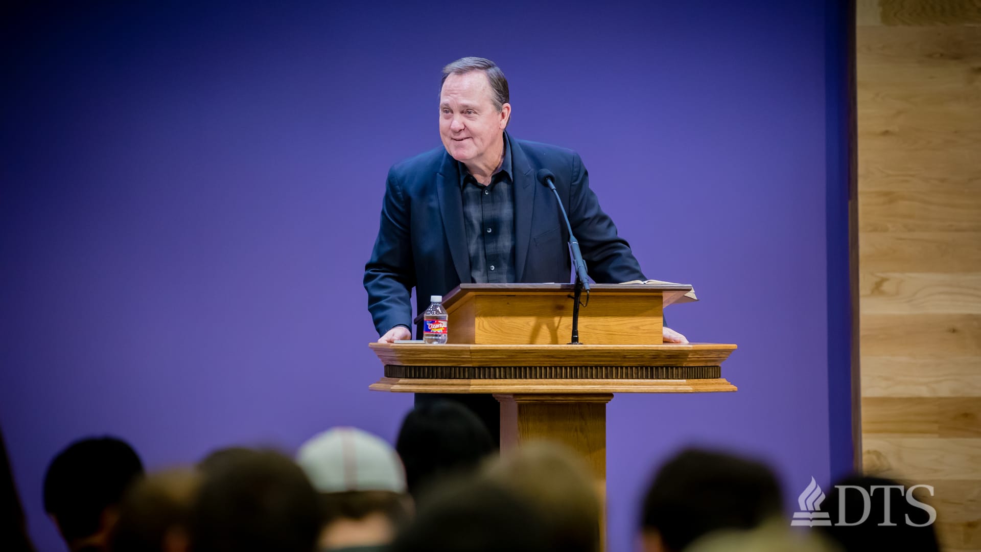 man standing at podium speaking at DTS Chapel