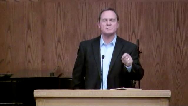 man standing at podium speaking at DTS Chapel