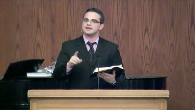 man standing at podium speaking at DTS Chapel