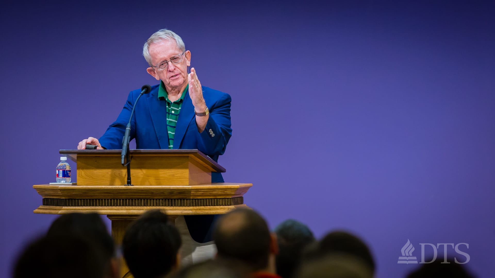 Dr. John Hannah standing at podium speaking at DTS Chapel