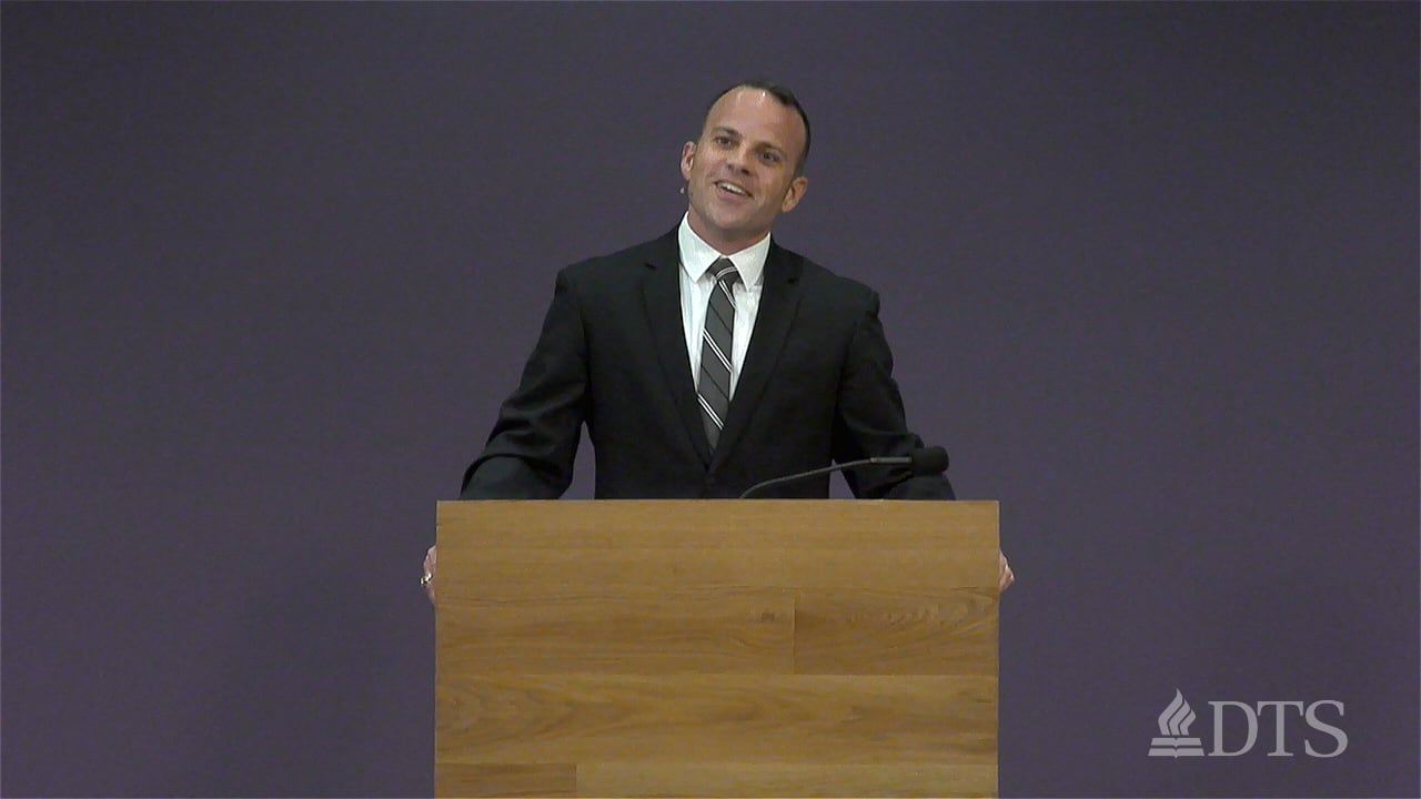 man standing at podium speaking at DTS Chapel