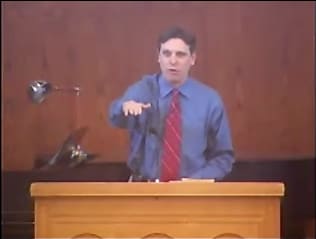 man standing at podium speaking at DTS Chapel