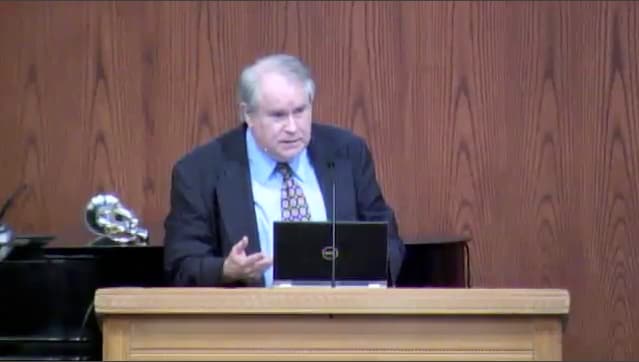 man standing at podium speaking at DTS Chapel