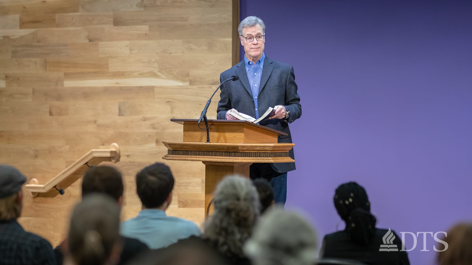 man standing at podium speaking at DTS Chapel