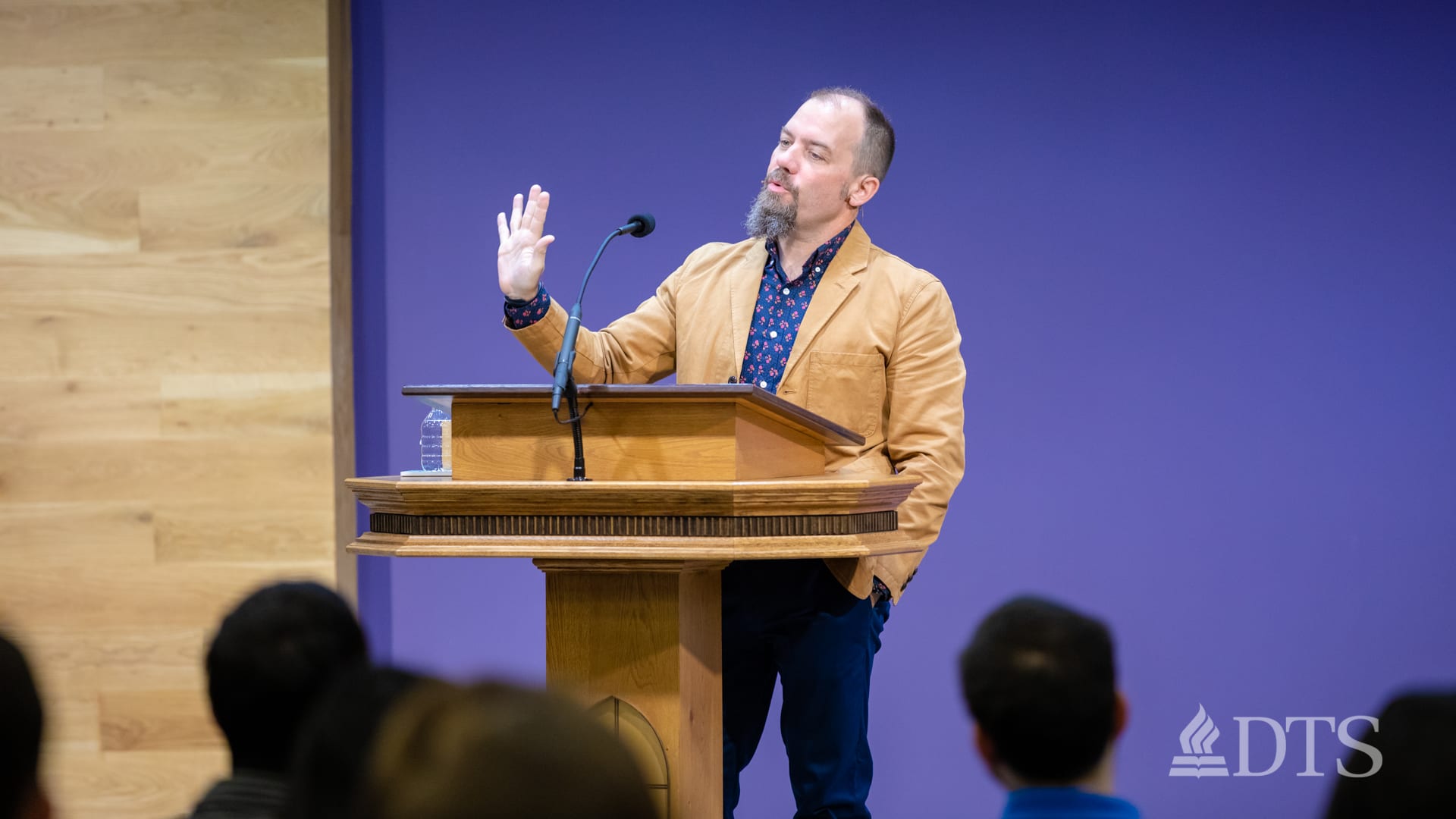 man standing at podium speaking at DTS Chapel