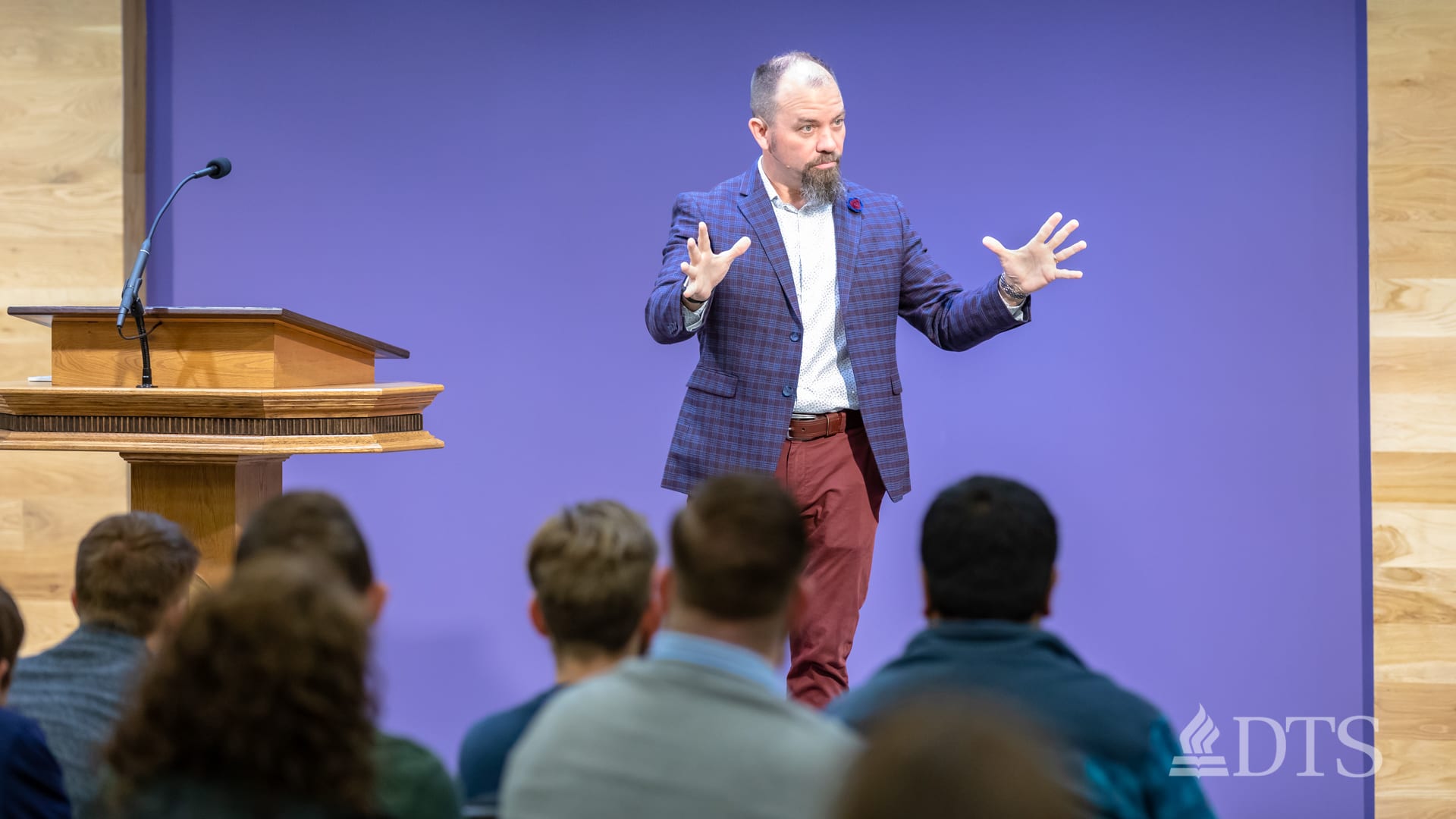 man standing near podium speaking at DTS Chapel