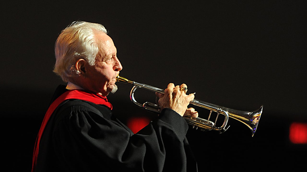 Bill Bryan playing the trumpet at commencement ceremony