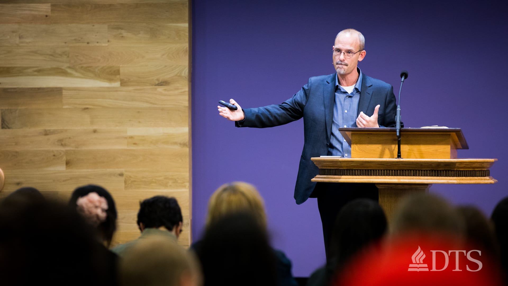 Dr. Michael Svigel standing at podium speaking at DTS Chapel