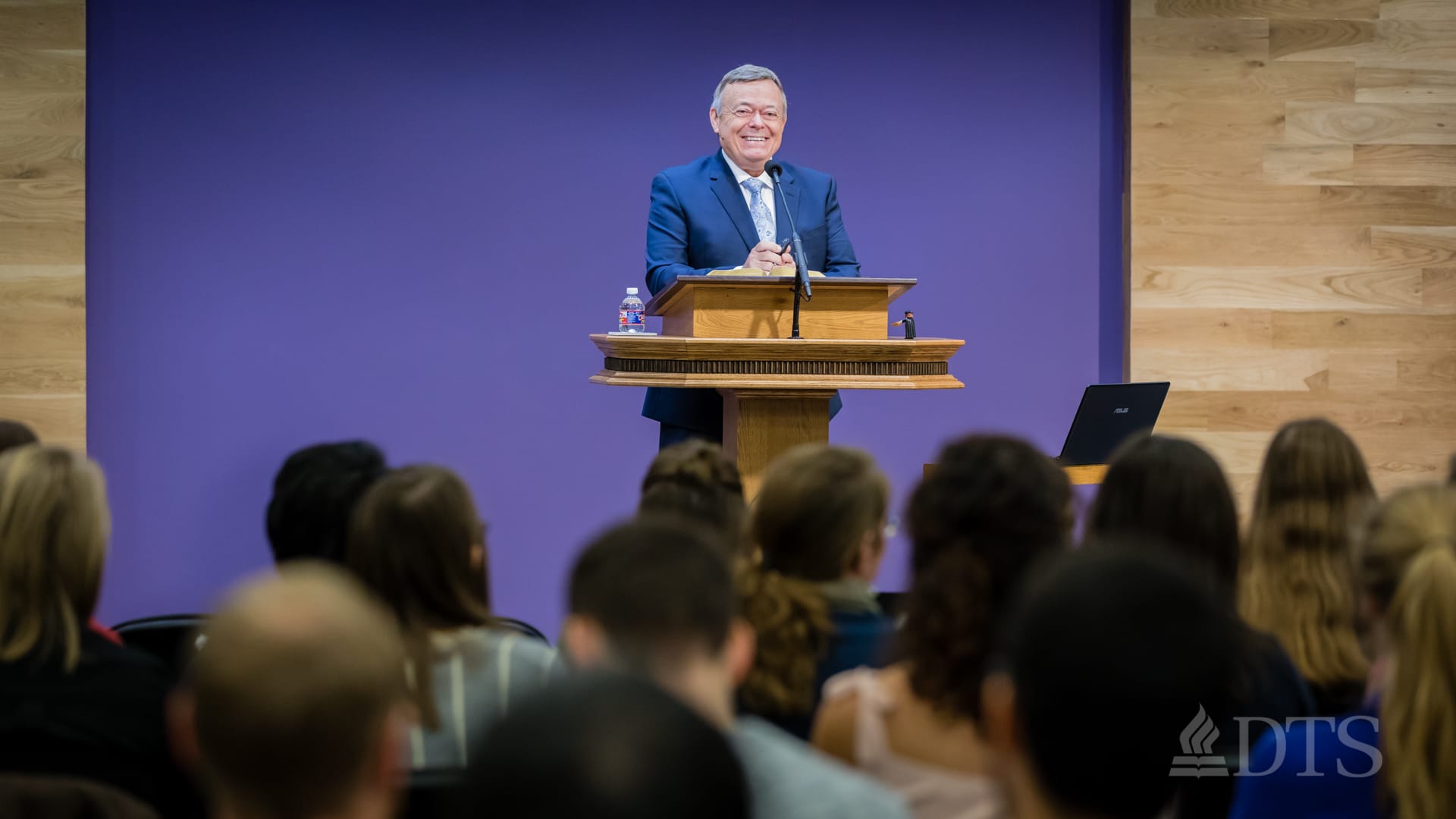 man standing at podium speaking at DTS Chapel
