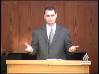 man standing at podium speaking at DTS Chapel