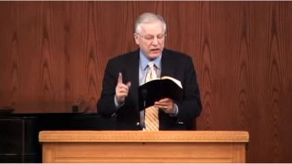 man standing at podium speaking at DTS Chapel