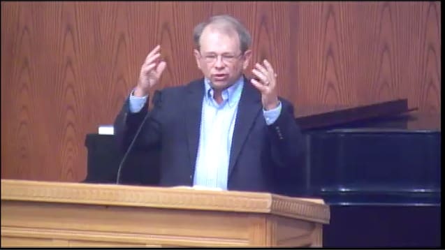 man standing at podium speaking at DTS Chapel