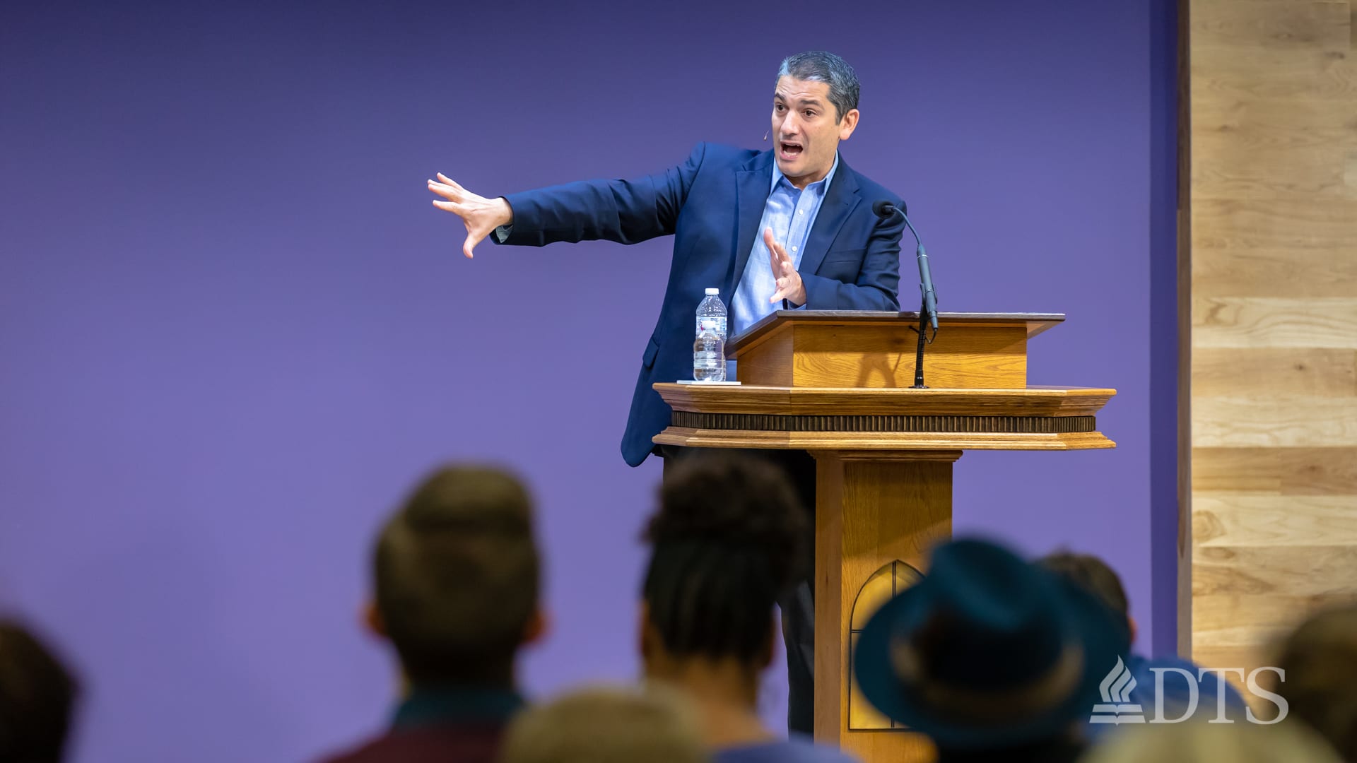 man standing at podium speaking at DTS Chapel