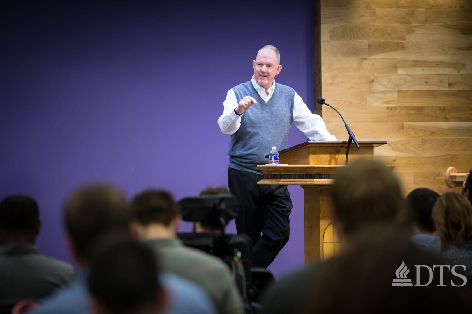 man standing at podium speaking at DTS Chapel