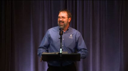 man standing at podium speaking at DTS Chapel