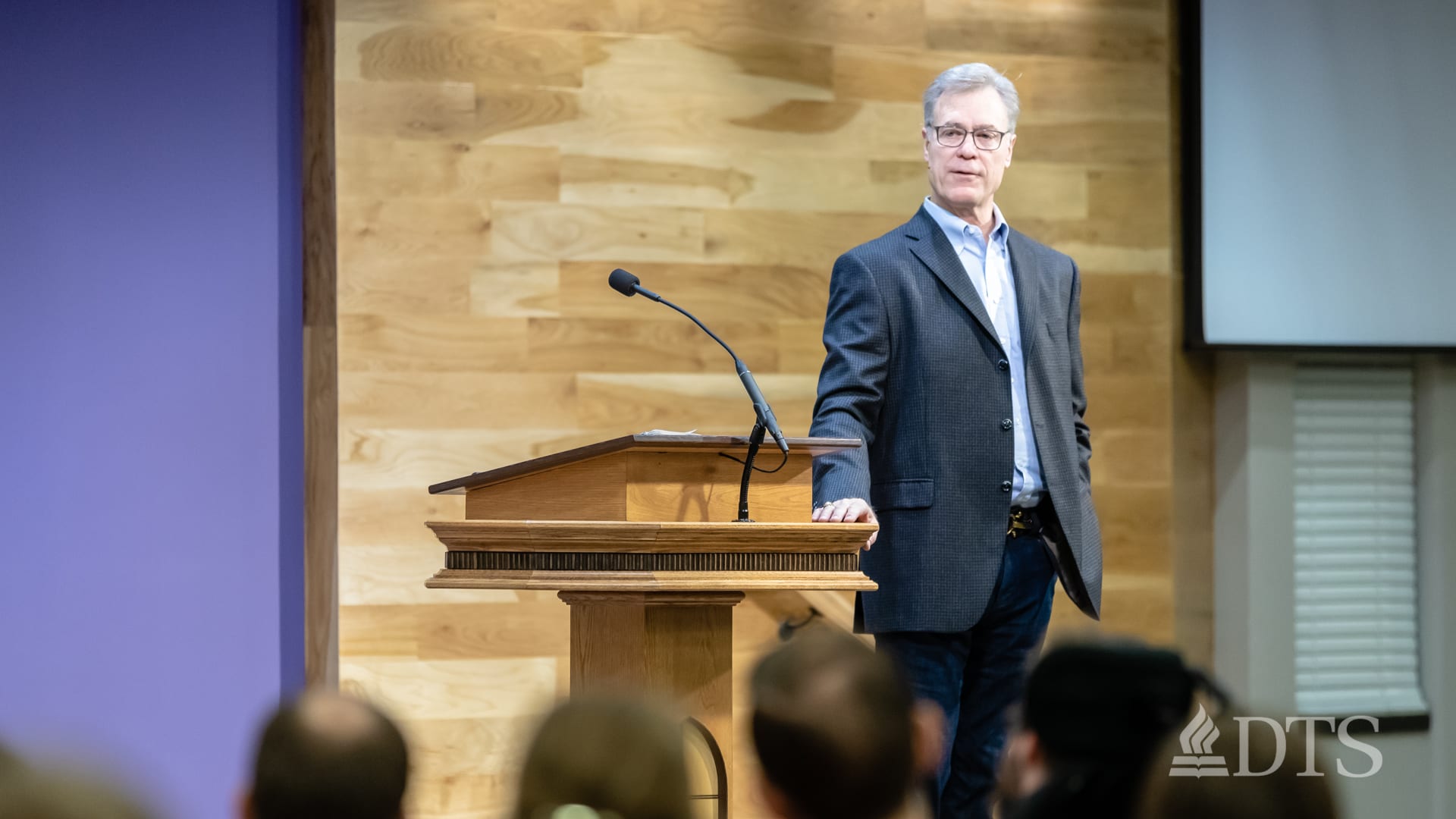 man standing near podium speaking at DTS Chapel