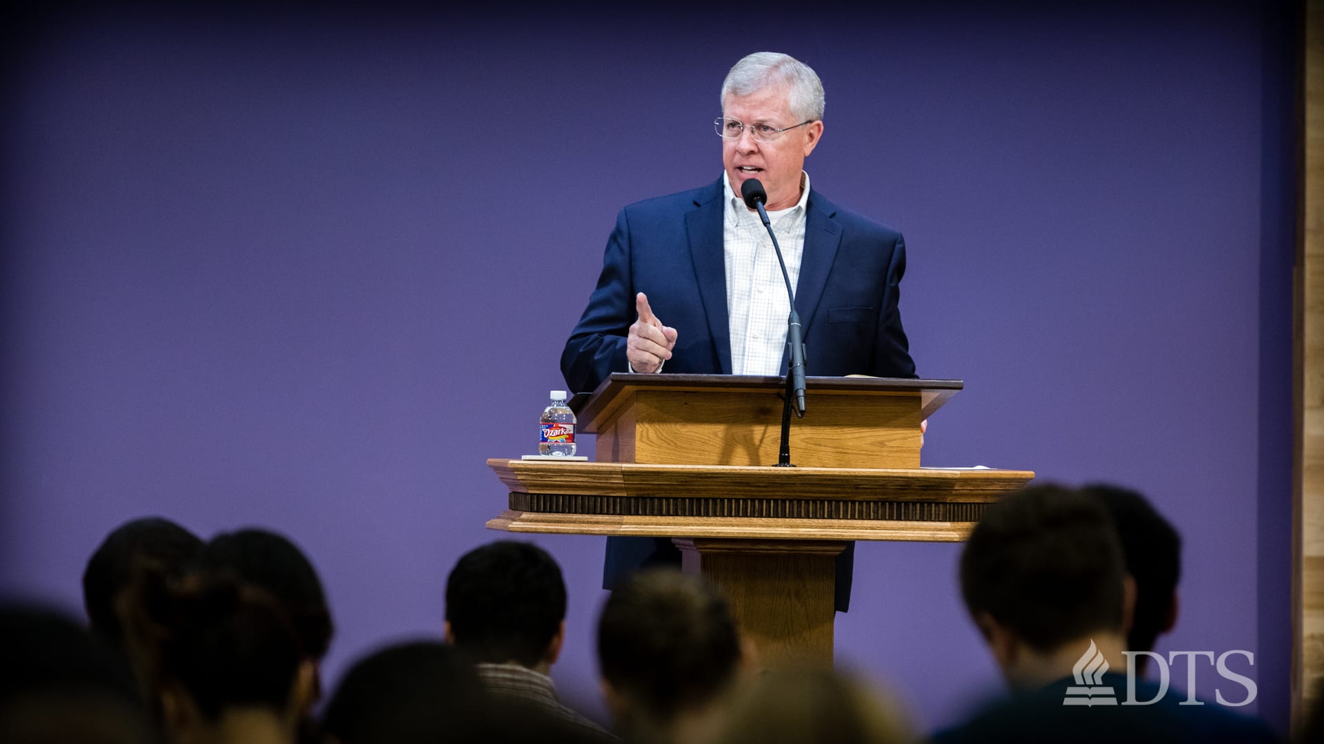man standing at podium speaking at DTS Chapel