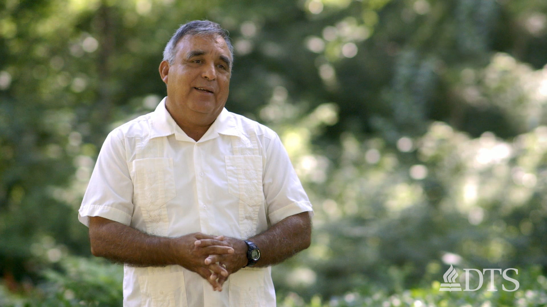 Amado Lozano standing outside talking with someone out of view