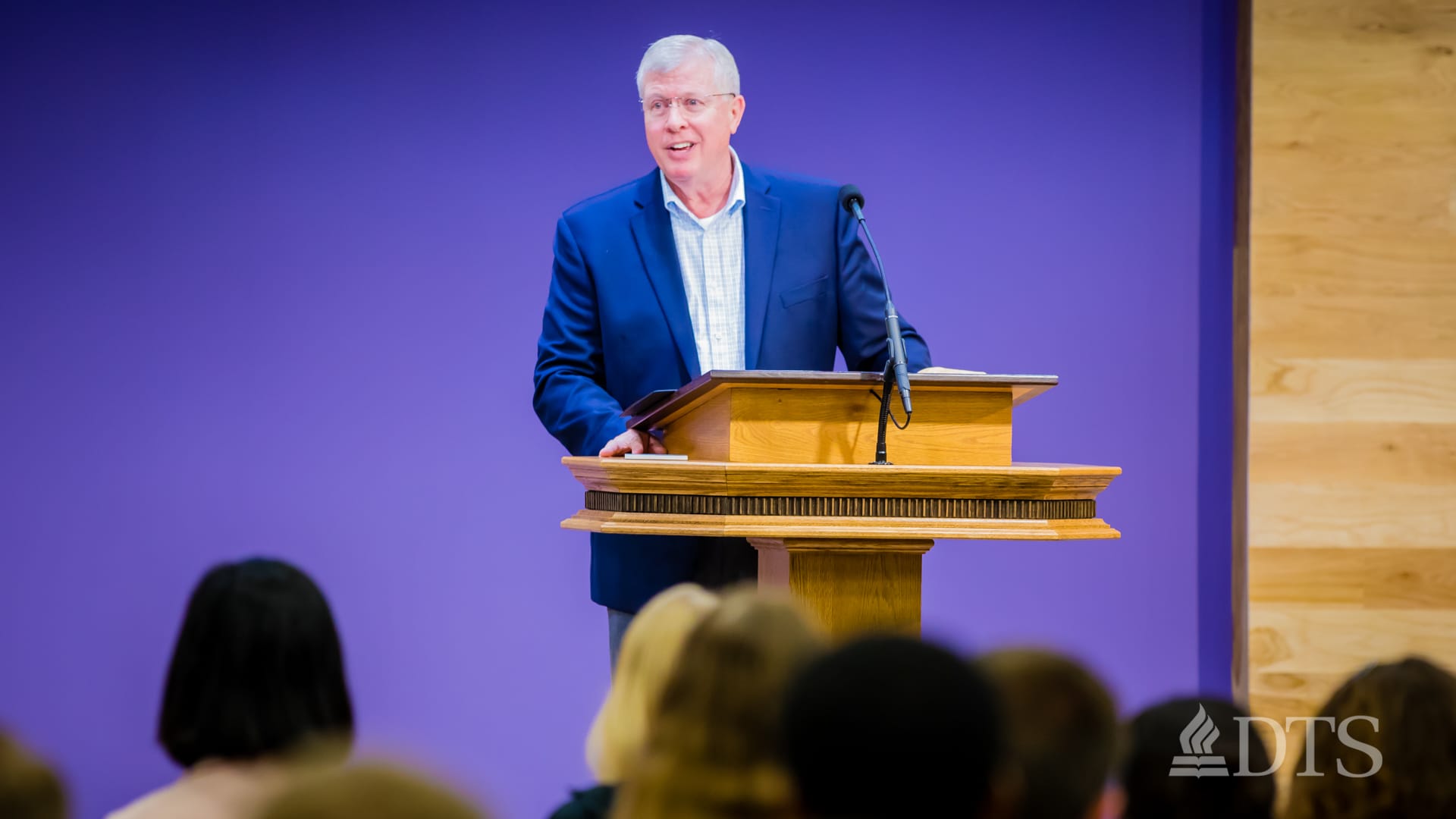 man standing at podium speaking at DTS Chapel