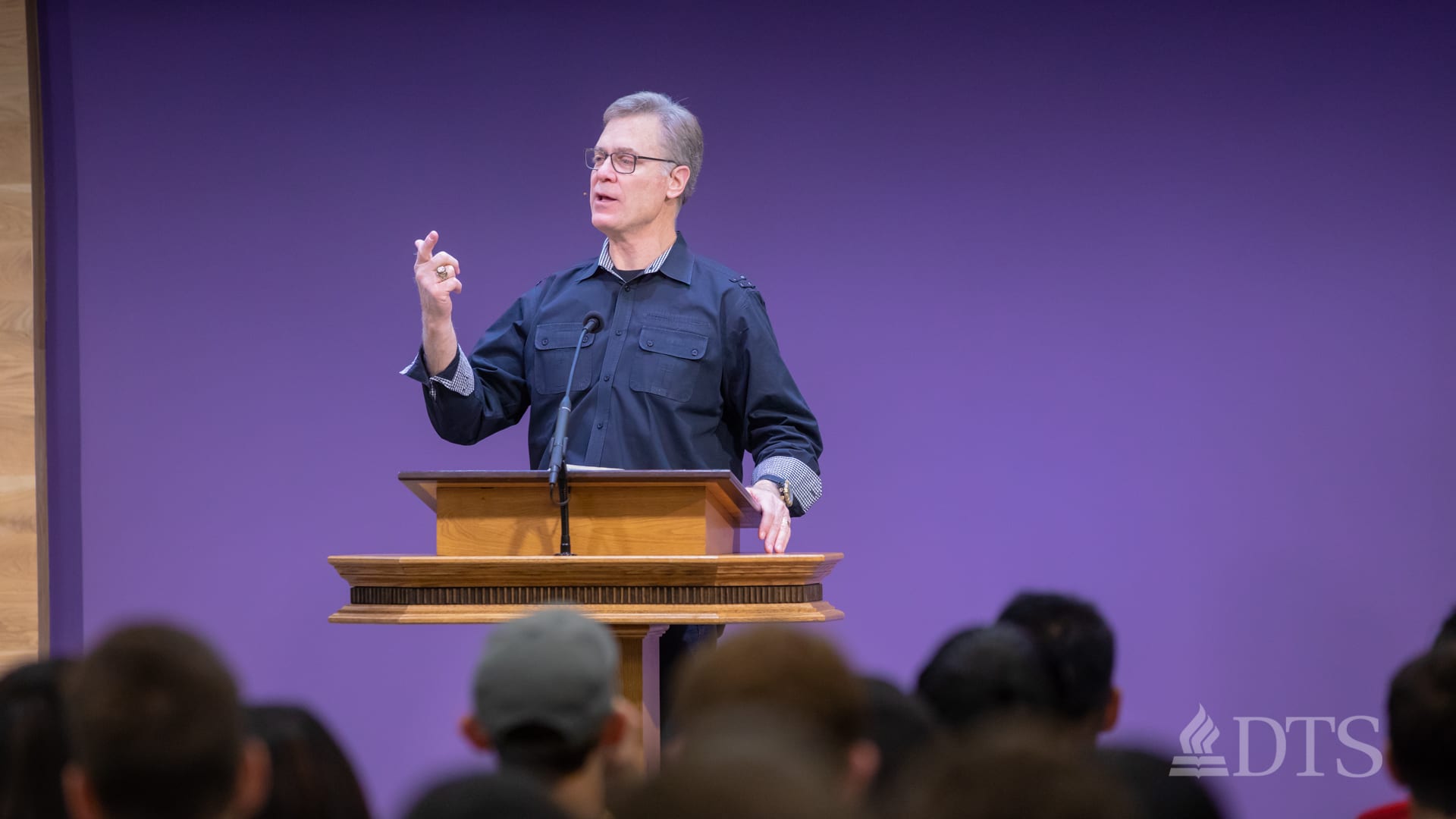 man standing at podium speaking at DTS Chapel