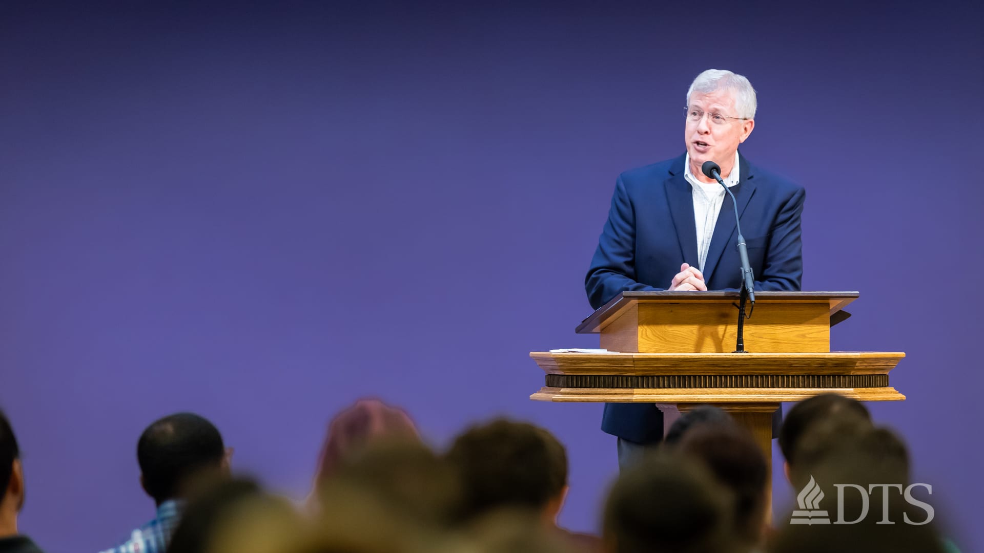 man standing at podium speaking at DTS Chapel