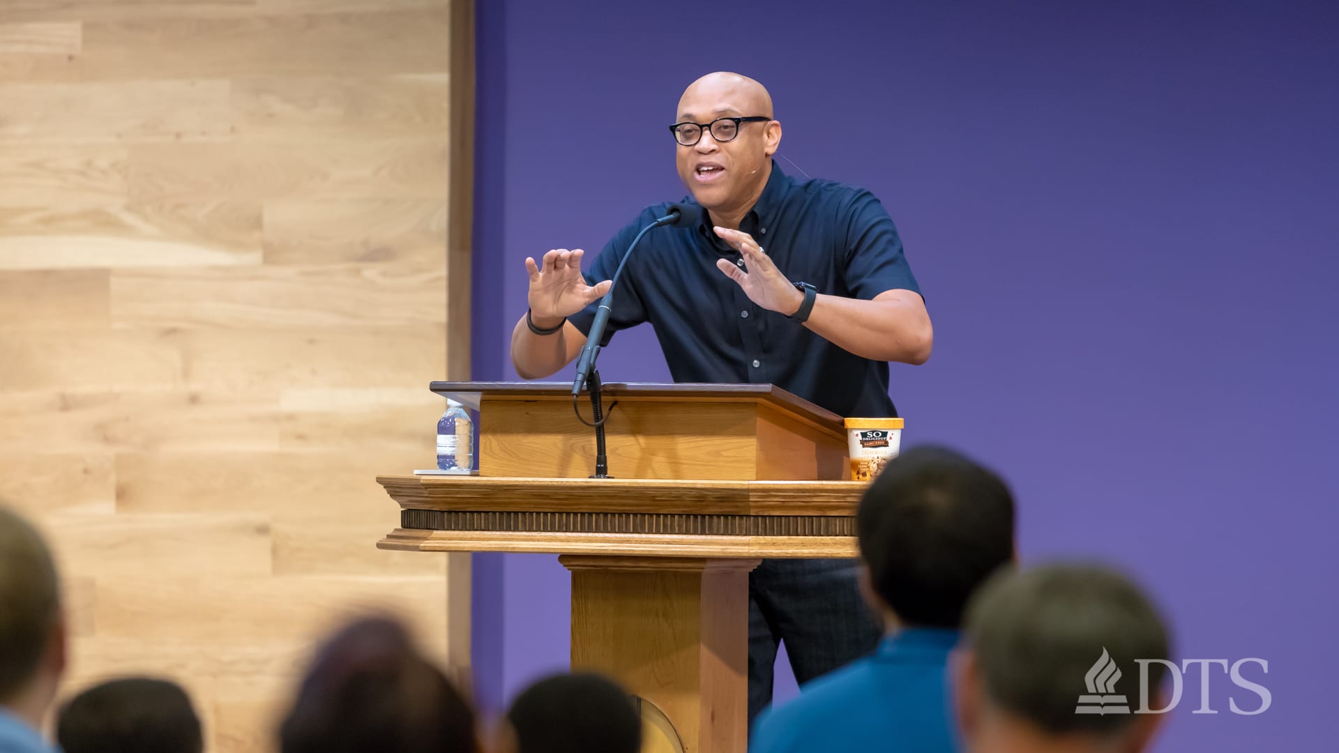 man standing at podium speaking at DTS Chapel