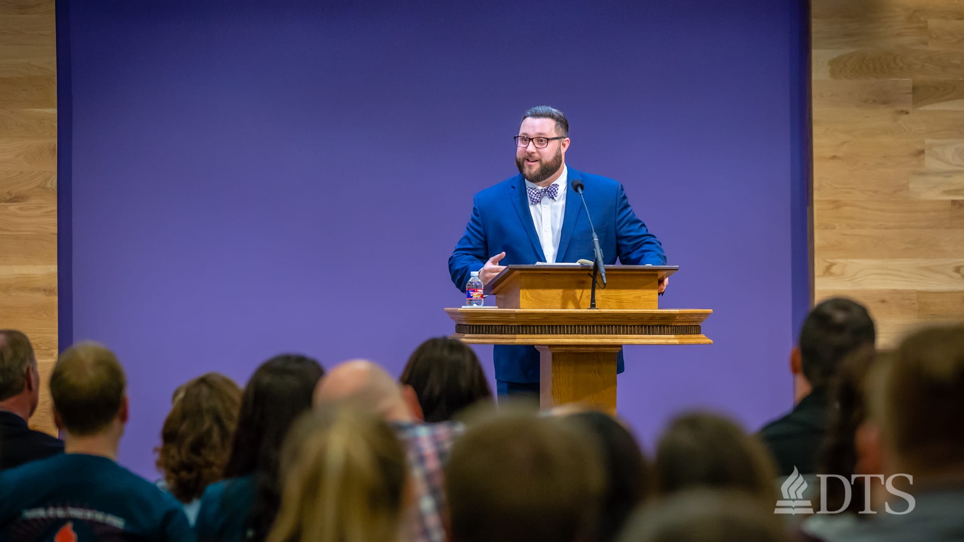 man standing at podium speaking at DTS Chapel
