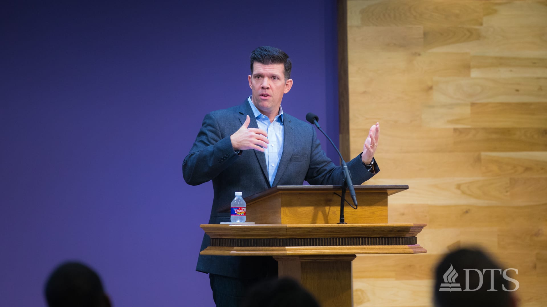 man standing at podium speaking at DTS Chapel