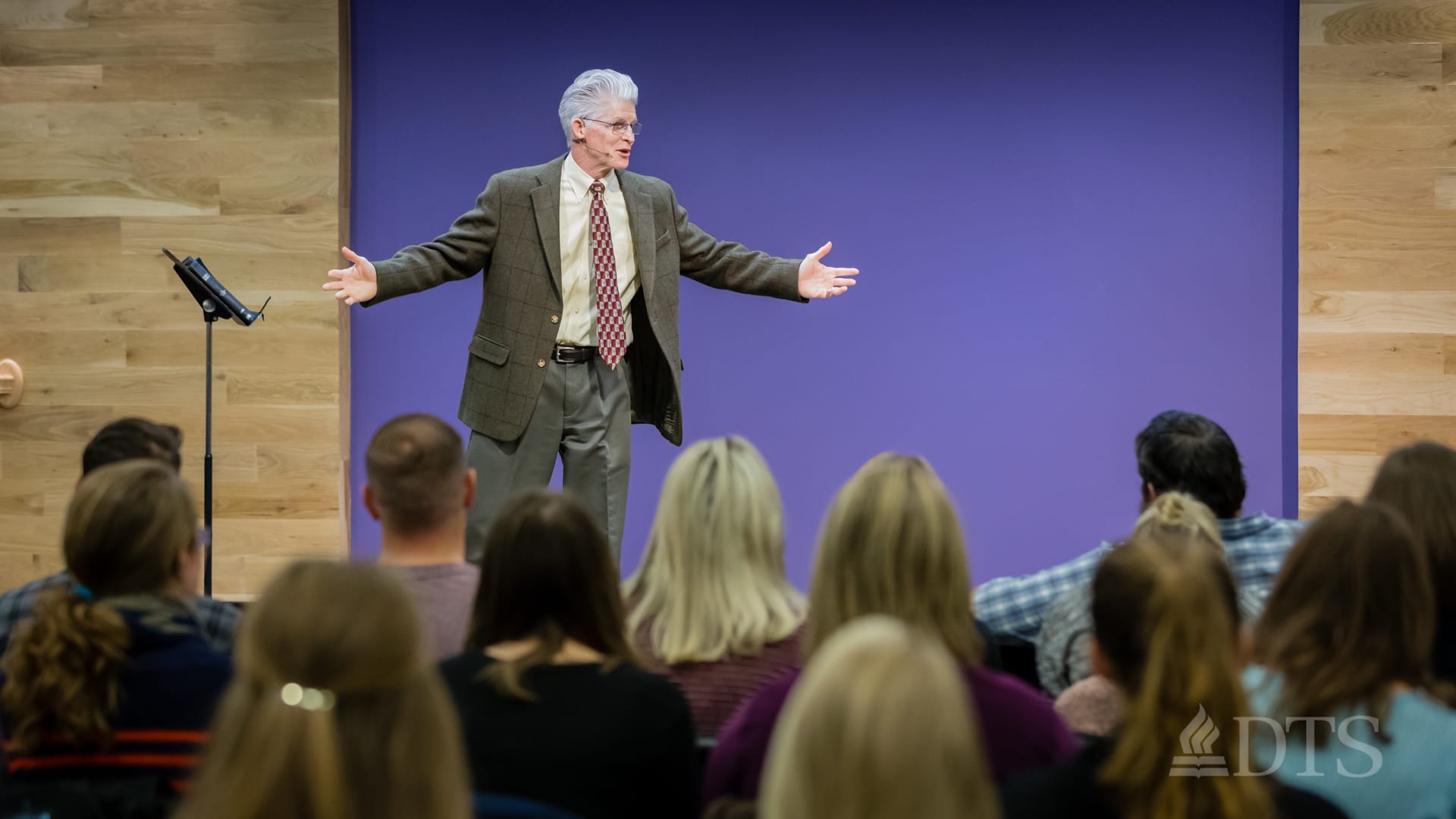 man standing on stage speaking at DTS Chapel