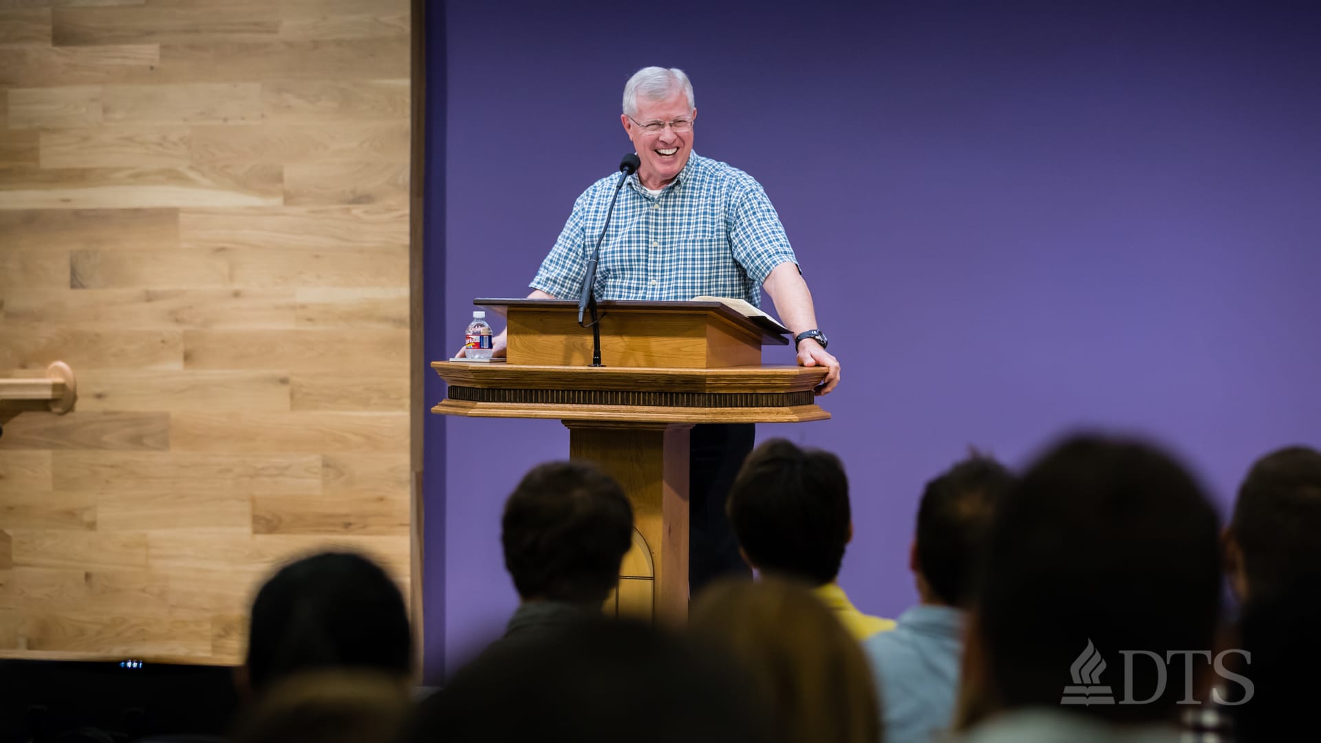 man standing at podium speaking at DTS Chapel