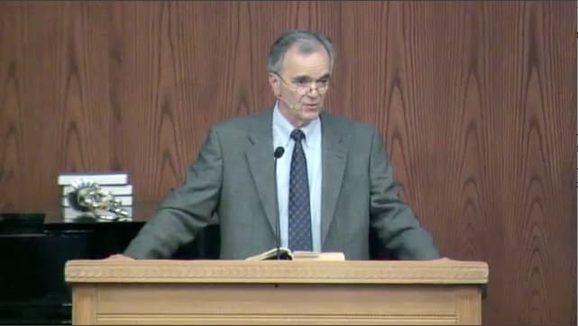 man standing at podium speaking at DTS Chapel