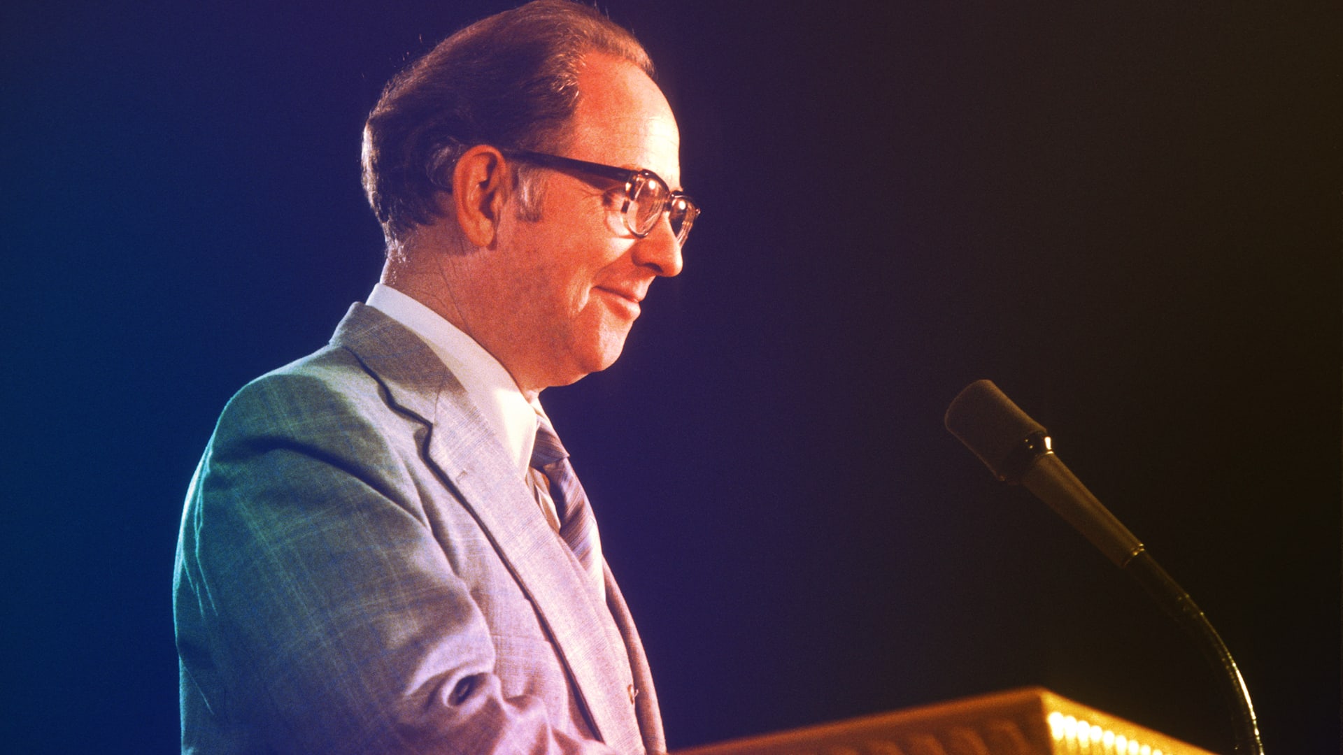 Dr. Campbell speaking into microphone at a podium