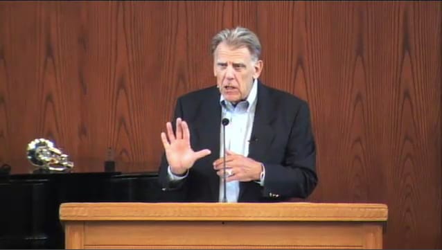 man standing at podium speaking at DTS Chapel