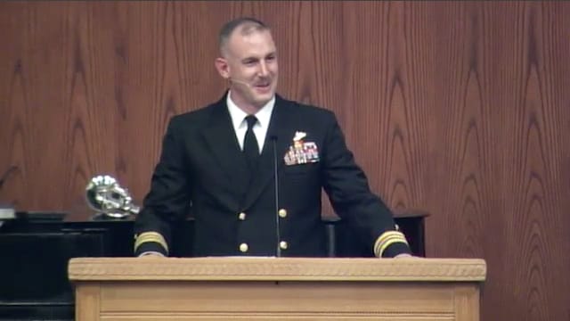 man standing at podium speaking at DTS Chapel