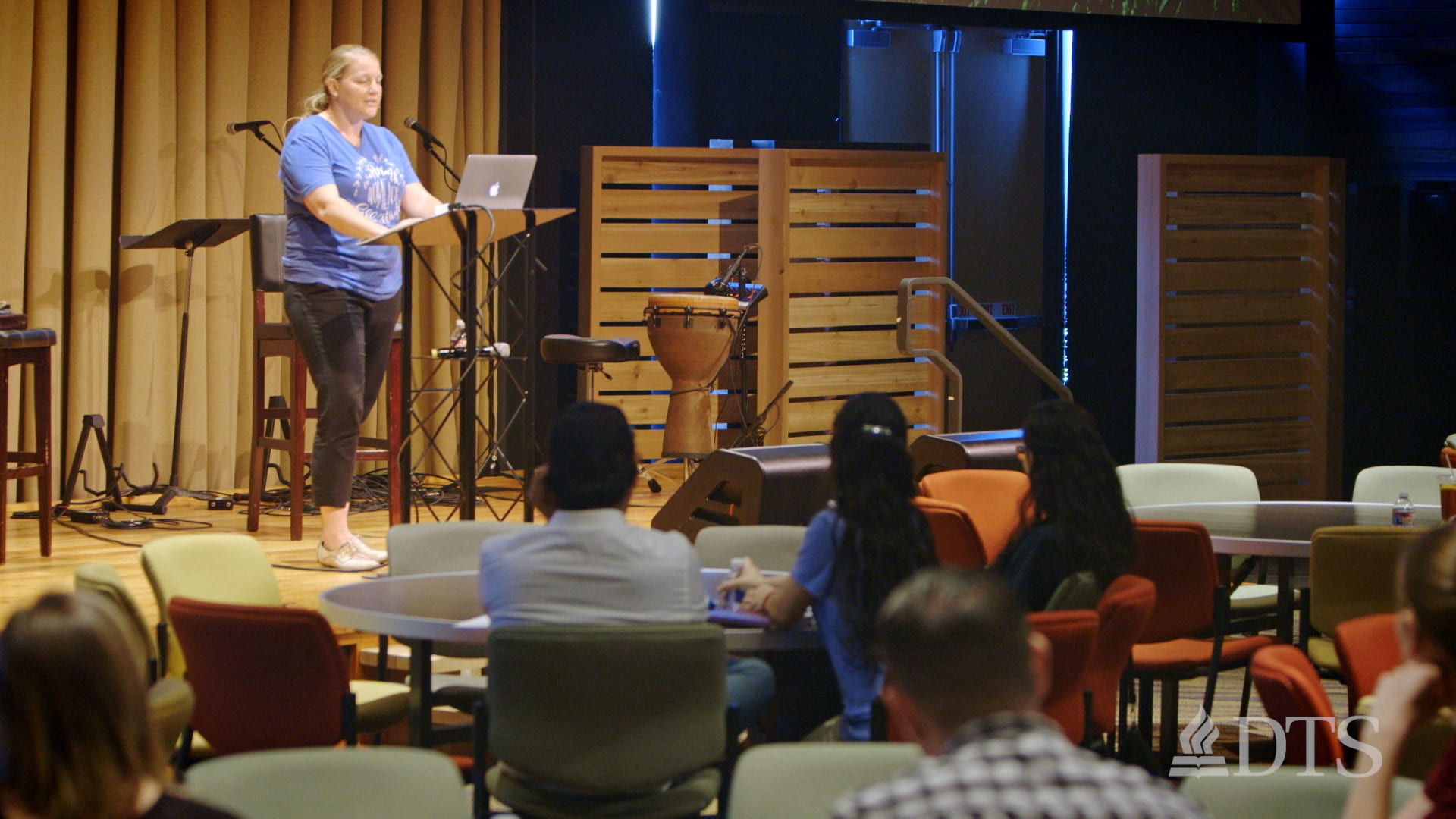 DTS alum Nika Spaulding speaks at a podium