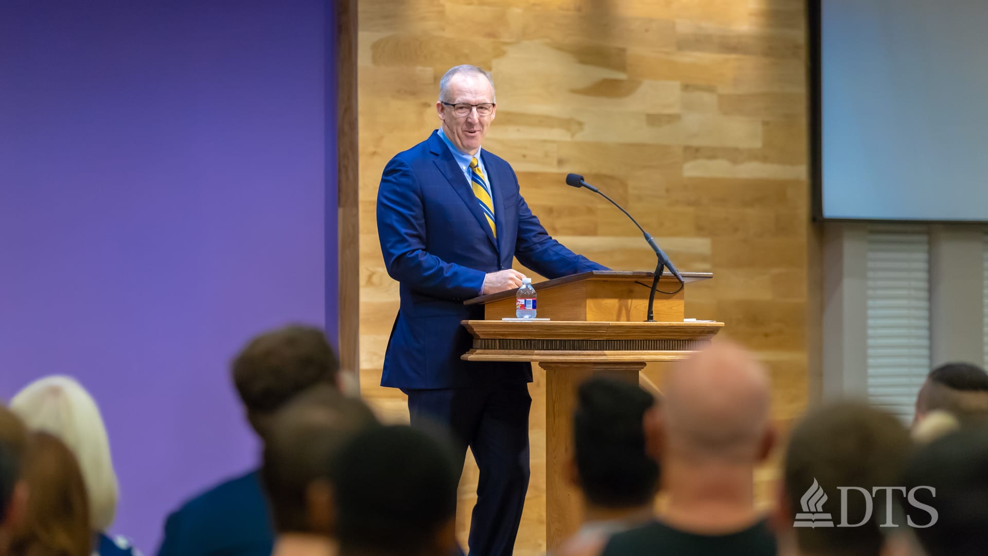 man standing at podium speaking at DTS Chapel