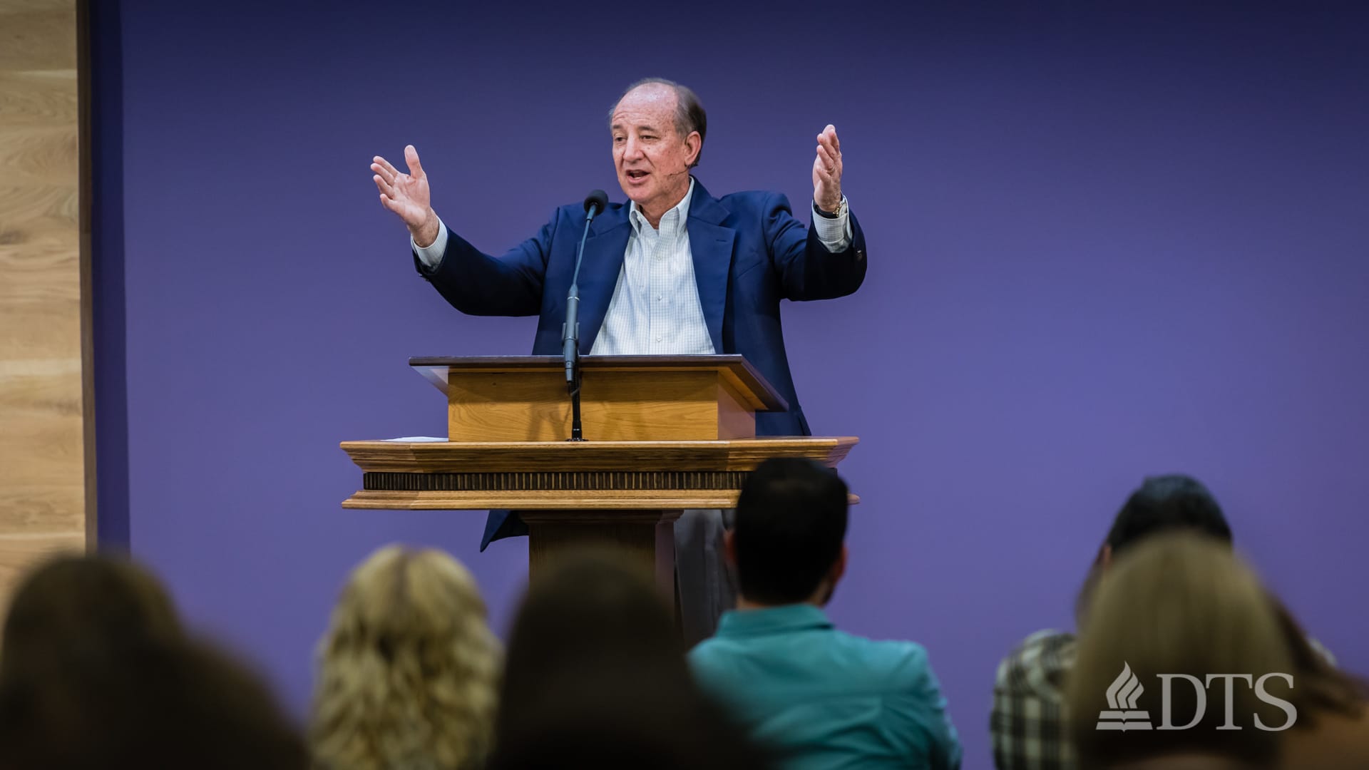 man standing at podium speaking at DTS Chapel