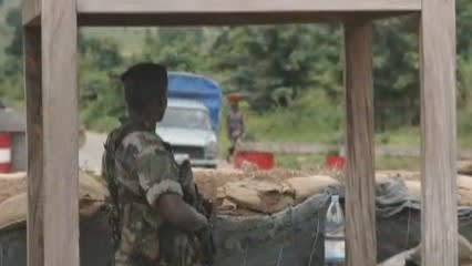 Soldier stands on guard as a man approaches