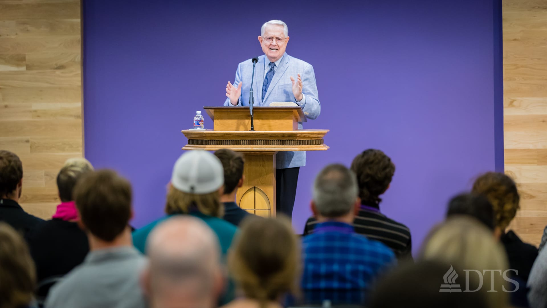 Dr. Chuck Swindoll standing at podium speaking at DTS Chapel