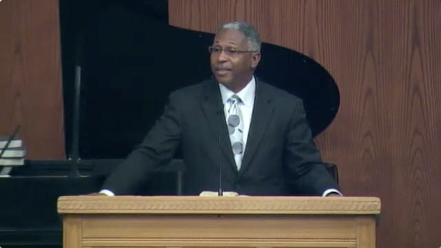 man standing at podium speaking at DTS Chapel