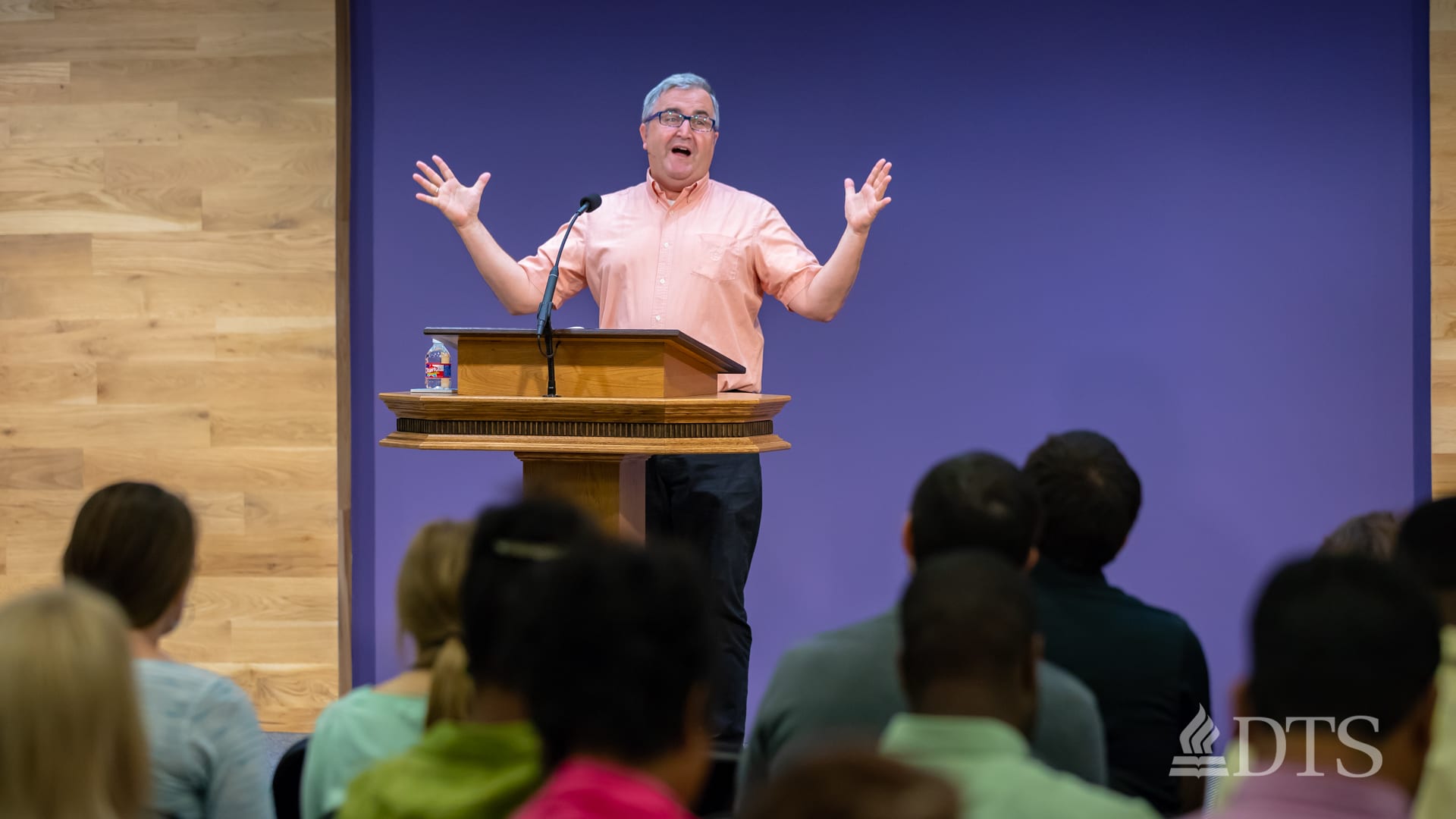 man standing at podium speaking at DTS Chapel